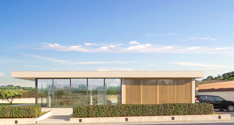 Street-facing facade of the two-bedroom villa with its vertical wood screen
